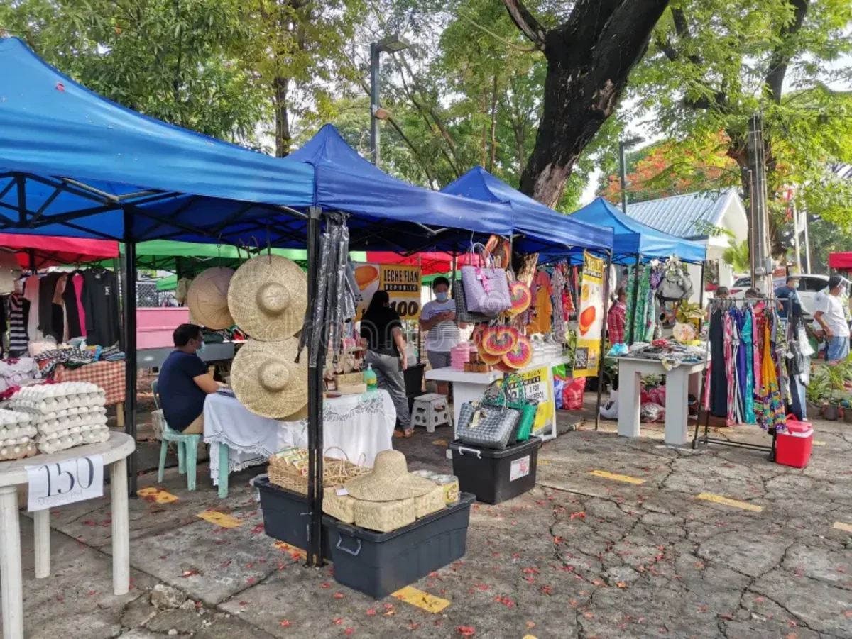 Market stalls under blue canopies