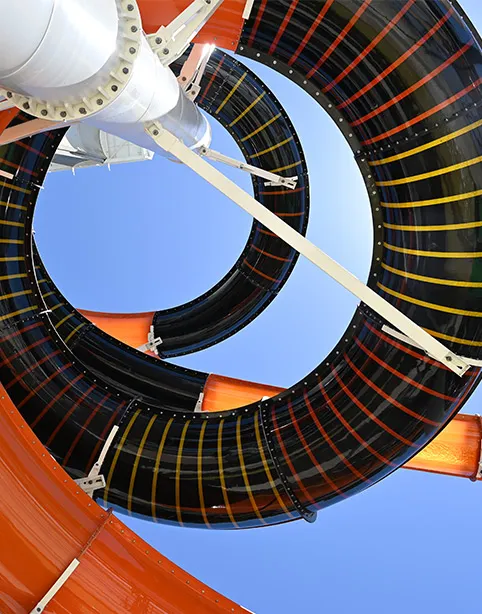 Looking up through the loops of a black waterslide