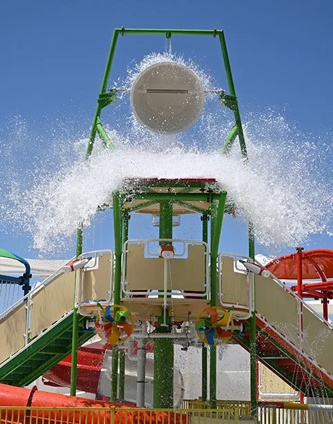 A giant bucket tipping water over the splash park